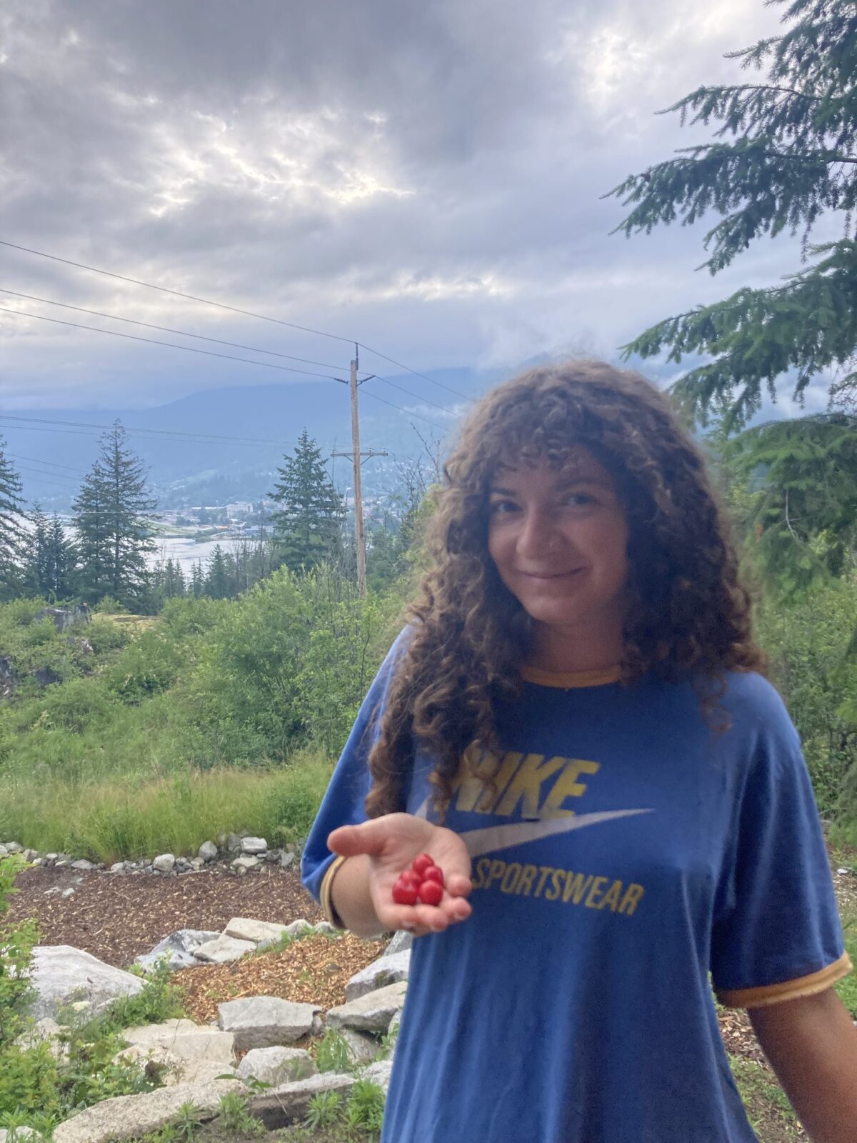 Portrait of Victory Shveyster holding 5 cherry tomatoes
